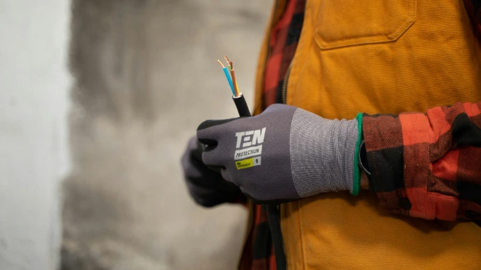 a person holding a pair of wires in their hands